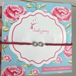 Silver infinity sign bracelet with red thread